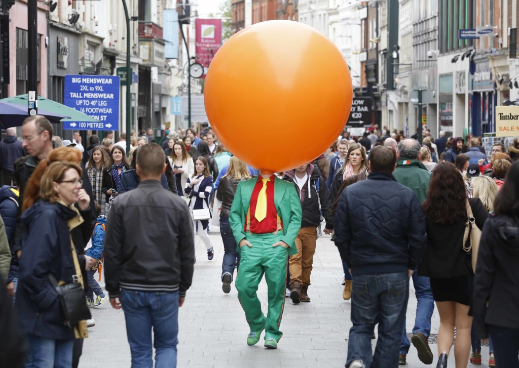 Danish performer Mr. Toons with a gigantic colourful party balloon on Dublin's Grafton Street