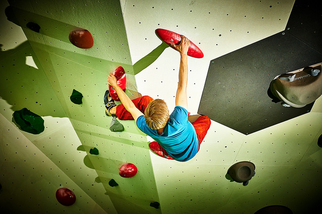 a child climbing an indoor climbing wall - bin the gym: 5 alternative ways to exercise after work