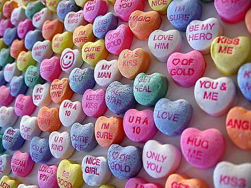 close up of loveheart sweets on a wall - office romance - the path to everlasting love