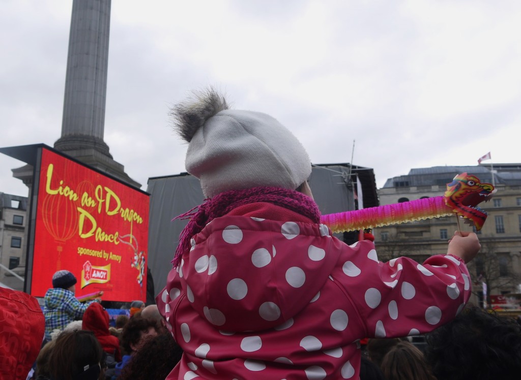 a child watching the Chinese New Year celebrations in Trafalgar Square