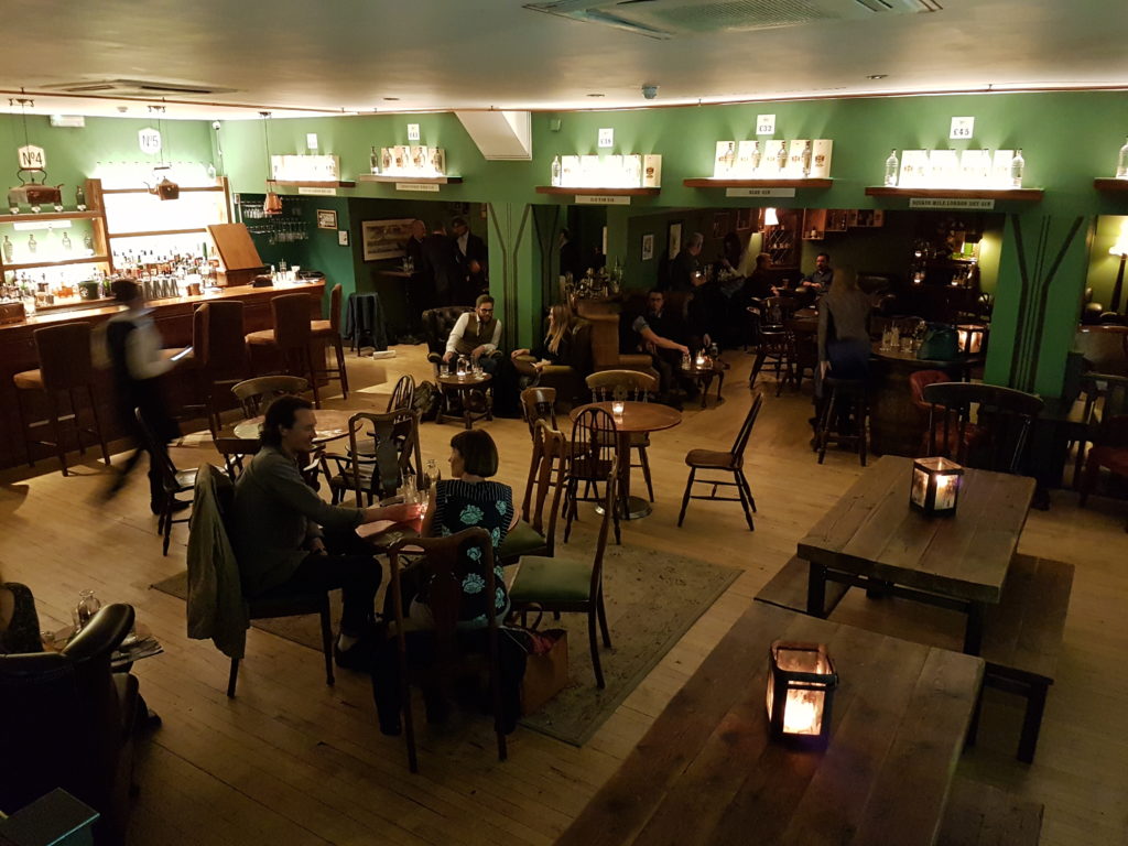 people sitting in the main bar area of the City of London Gin Distillery 