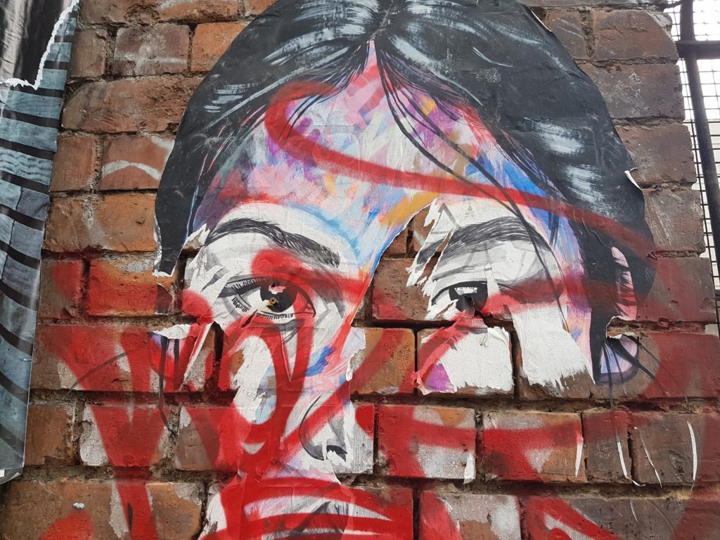 close up of woman's face on Sclater Street, Shoreditch in London 