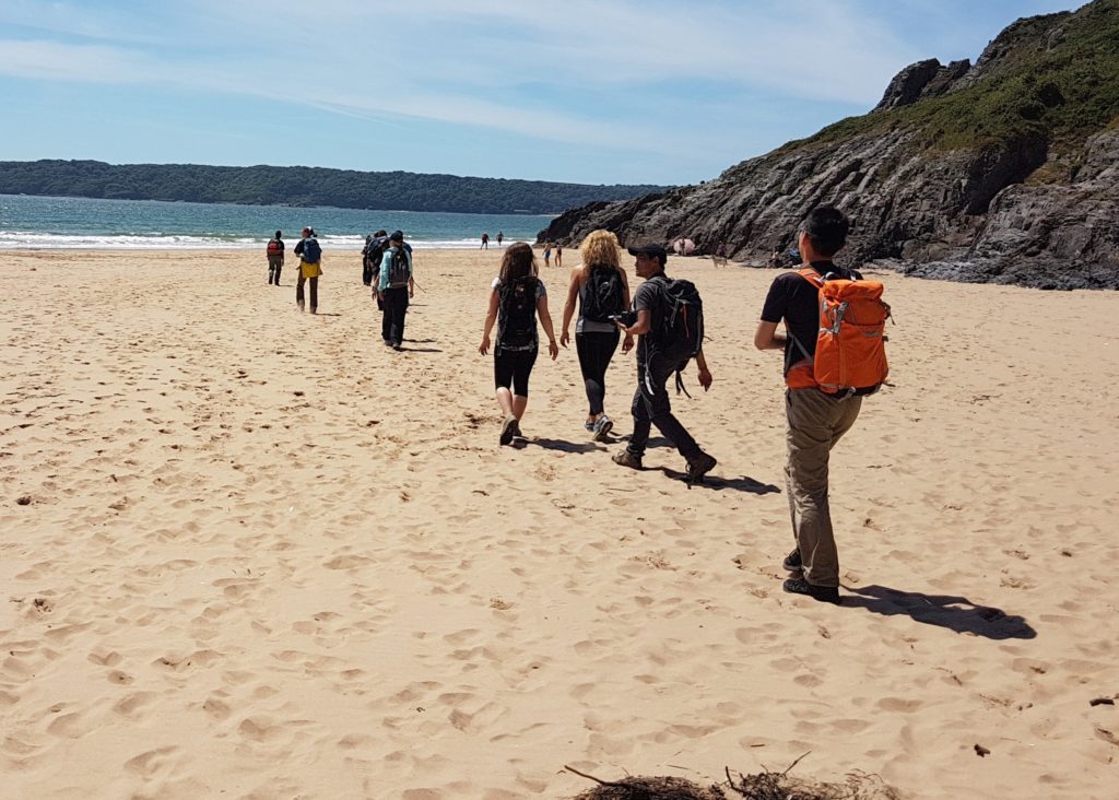 Close up of hikers on Oxwich Beach, Gower Peninsula
