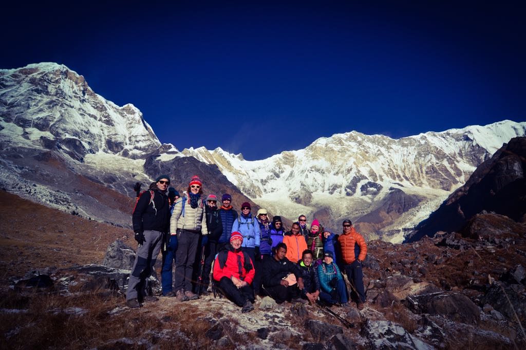 posing for a group photo at Annapurna Sanctuary base camp 
