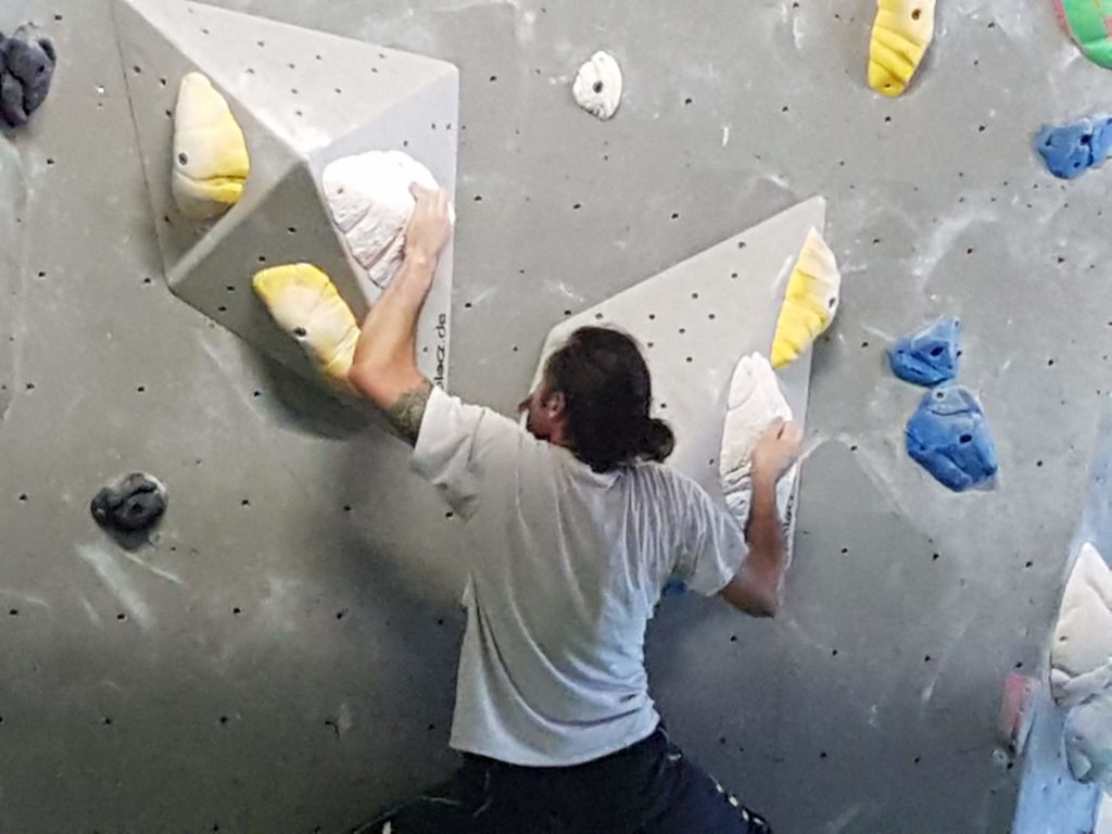 close up of man bouldering at the Arch Climbing Wall in Burnt Oak