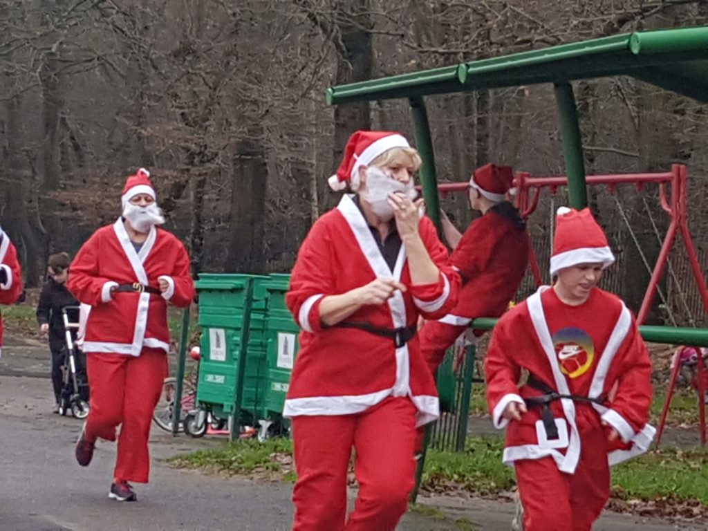Santa dash runners in Santa costume running around Ruislip Lido