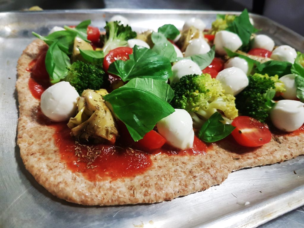 vegetables on home-made pizza a holiday at home idea