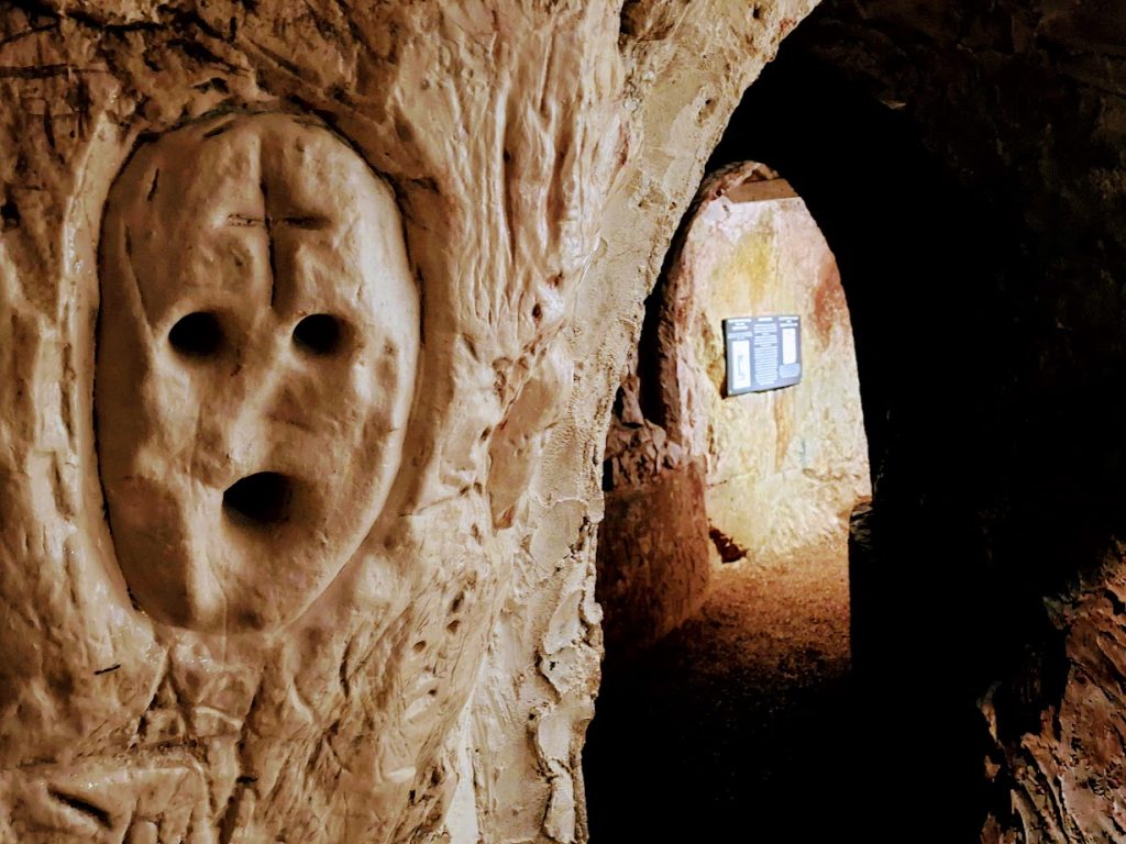 face carved into the wall of the hellfire caves
