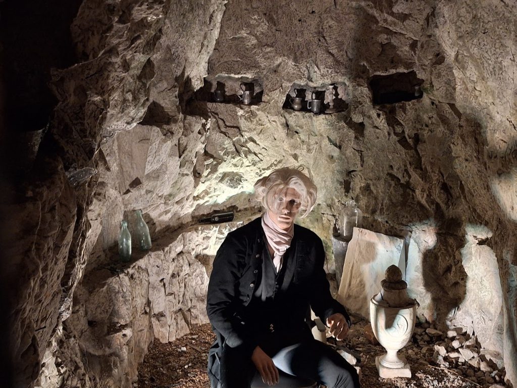 wax work of Paul Whitehead and his urn at the hellfire caves