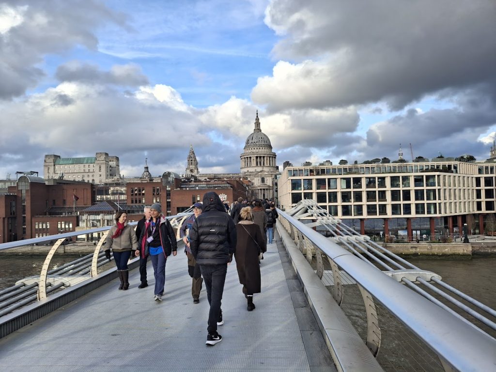 Walking along the Millennium bridge facing St Paul's Cathedral