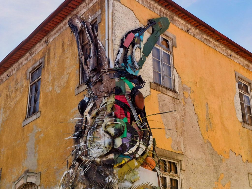 Giant half rabbit sculpture on the side of a building in Vila Nova de Gaia, Portugal